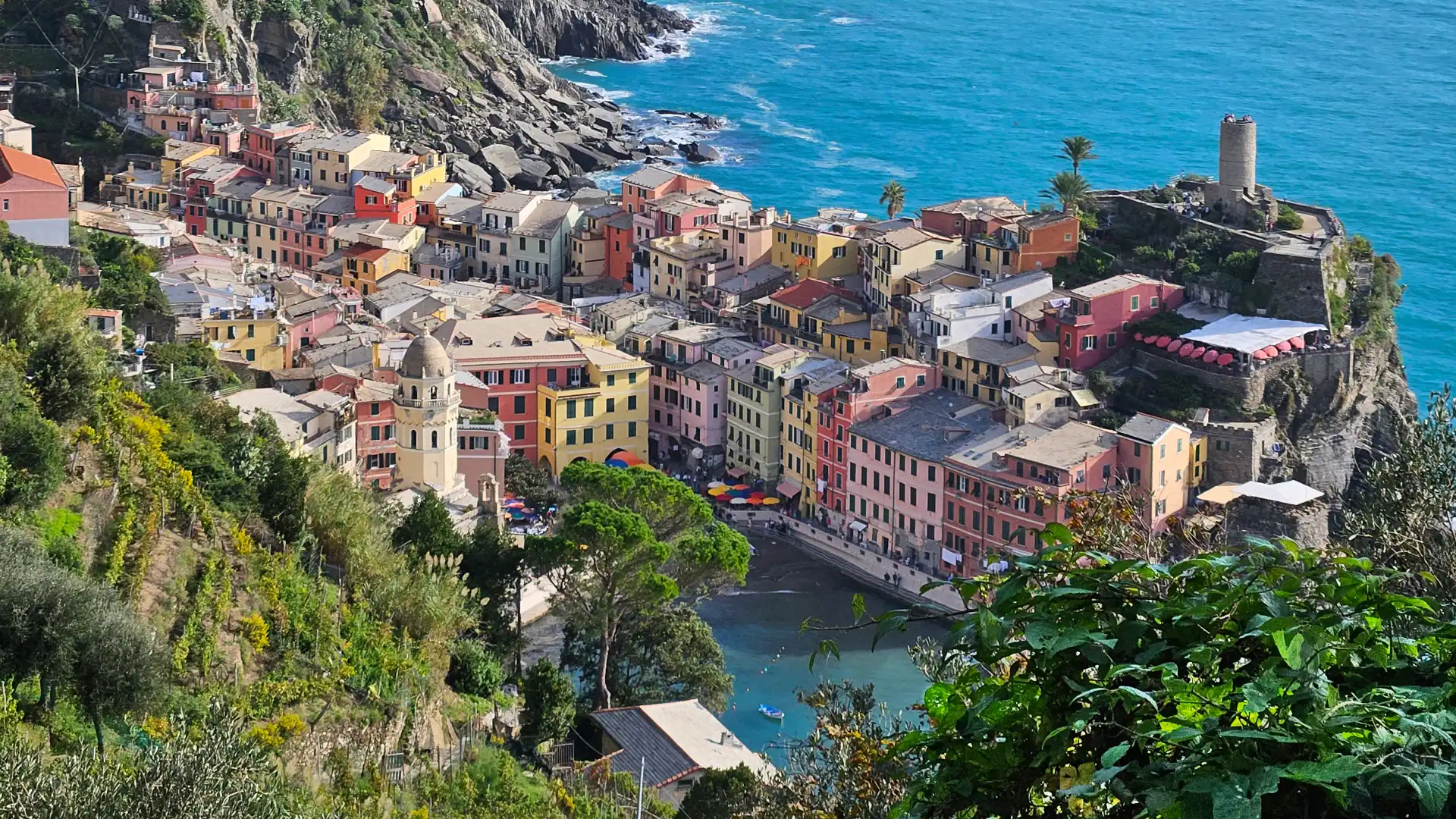 View of famous Cinque Terre city, Vernazza, from a cliffside vantage point along the Sentiero Monterosso hiking trail.