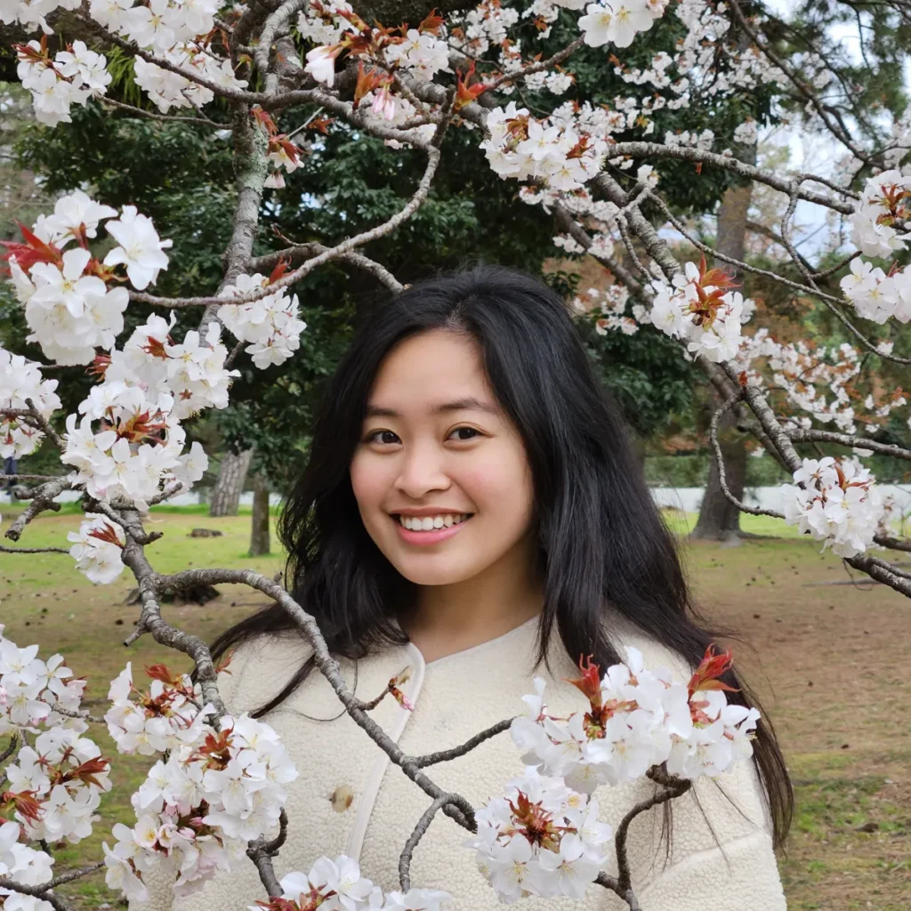 Zoe with cherry blossoms in Japan.