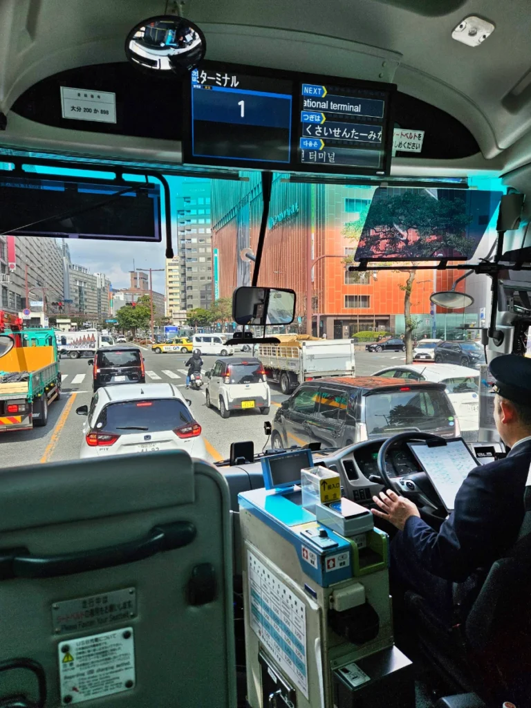 View of Japanese bus driver and the front of the bus as we make our way through Fukuoka, Japan via public transportation.