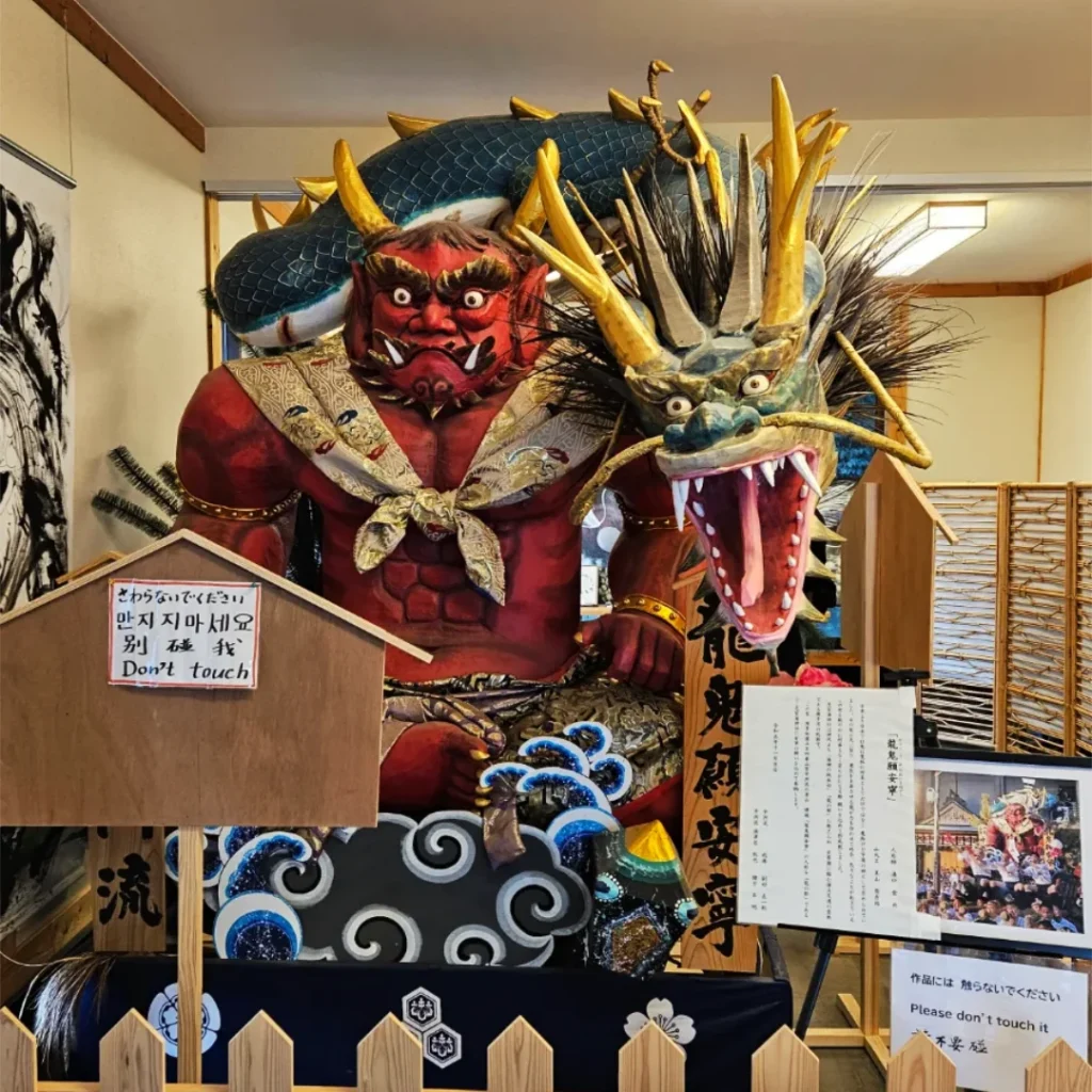 Sculpture of an oni and a dragon at the museum in the Shikaumi Shrine grounds.