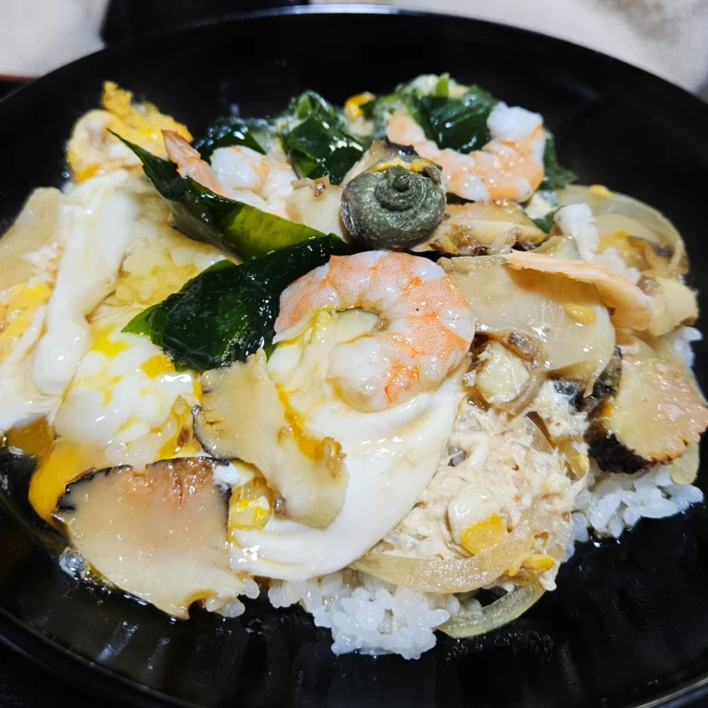 Sazae-don set of rice, grilled turban shells, shrimp, and egg from Nakanishi Shokudo.