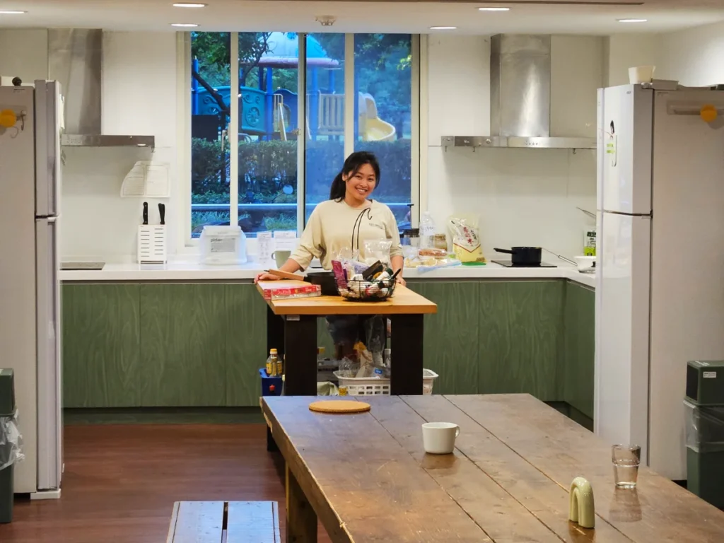 Zoe preparing a meal in the kitchen of a co-living accommodation.