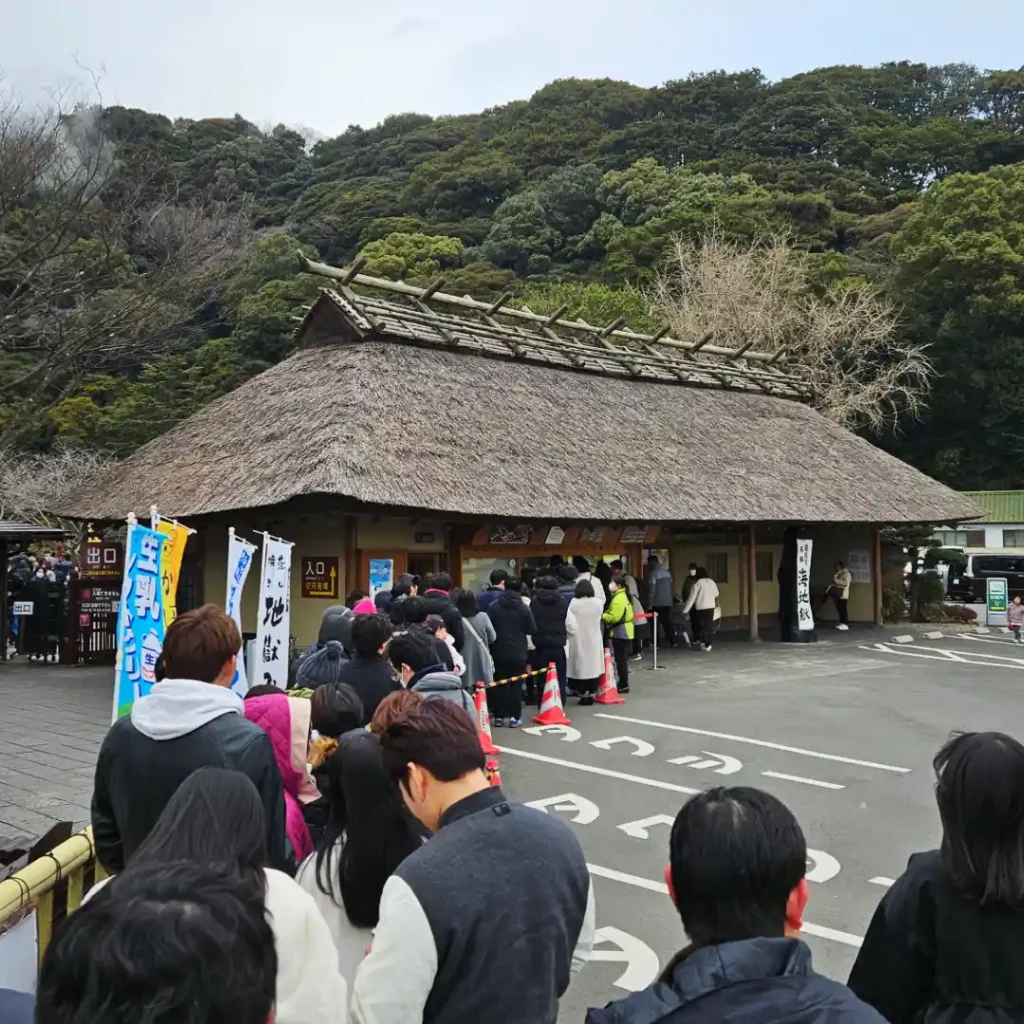 A queue of tourists at the Umi Jigoku ticket counter located in Beppu.