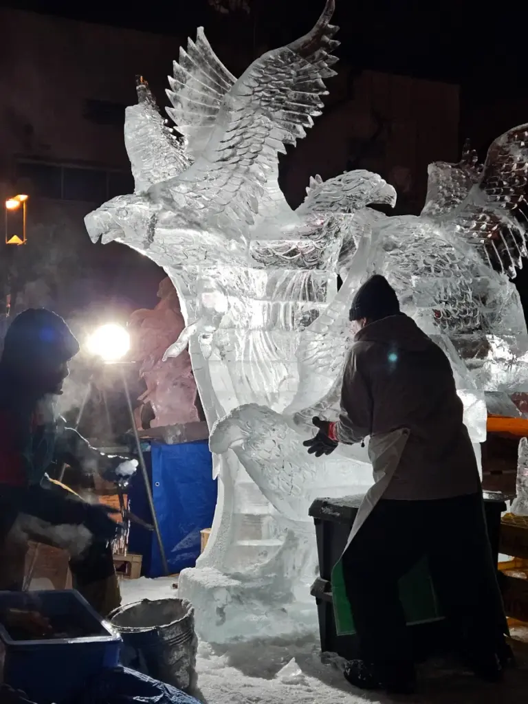 Ice sculptors preparing for the World Ice Craving Championship with their ice sculpture of eagles.