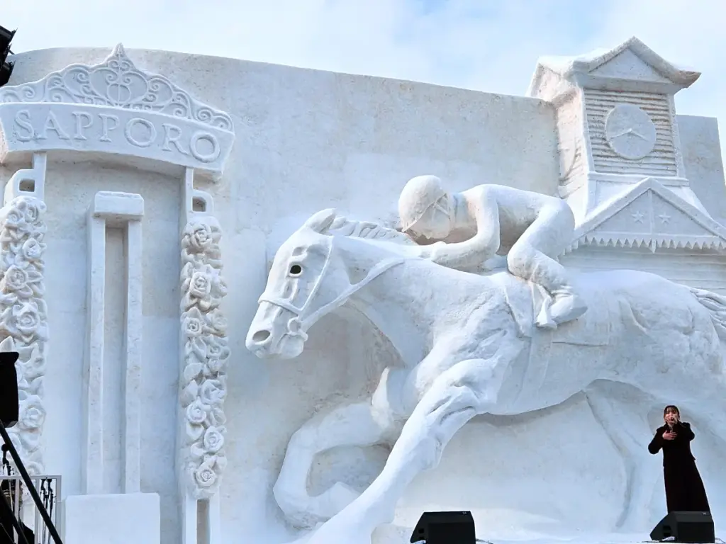 A massive snow sculpture of a man on his horse at the Sapporo Snow Festival.
