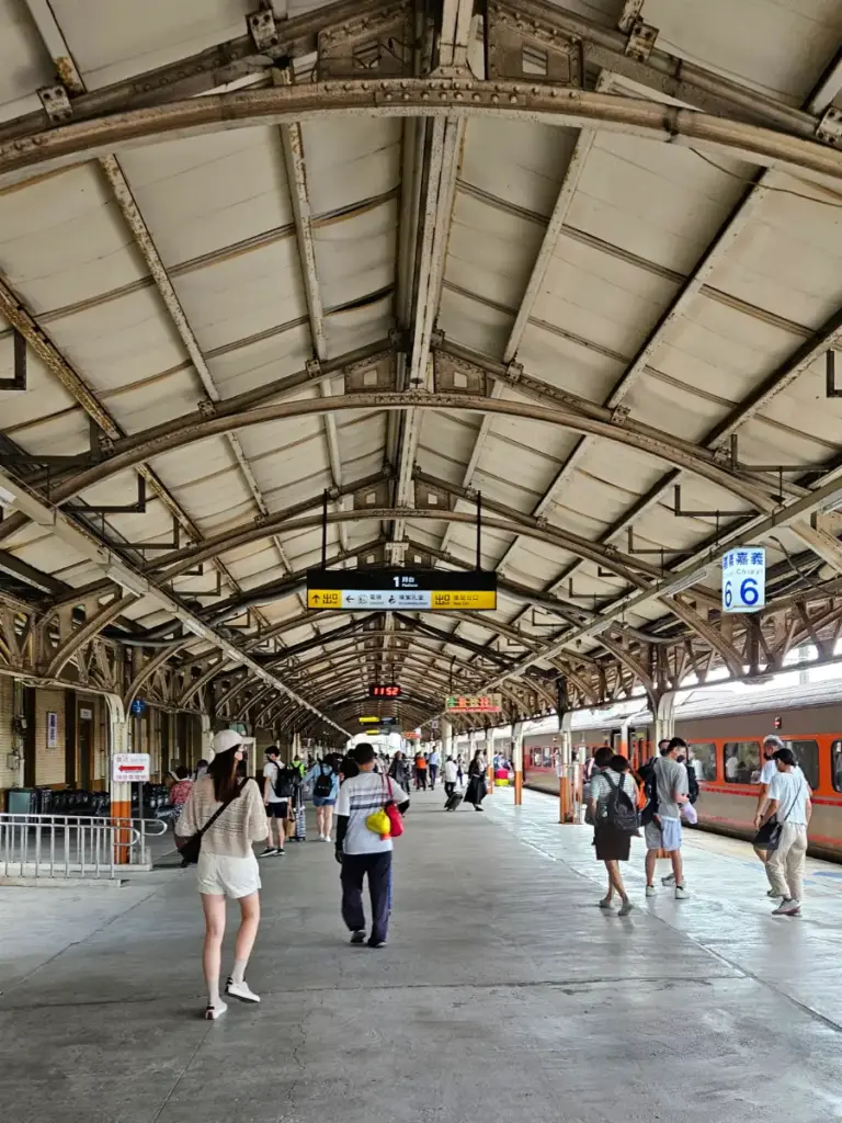 Travelers walking along the platform at the Chiayi TRA train station, the starting point for our slow travel Taiwan experience.