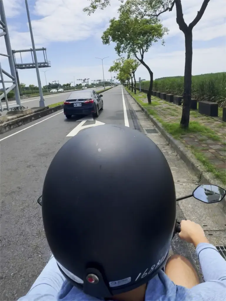 Point-of-view shot from the back of a scooter riding down a tree-lined lane on the way to Dongshi, Taiwan.