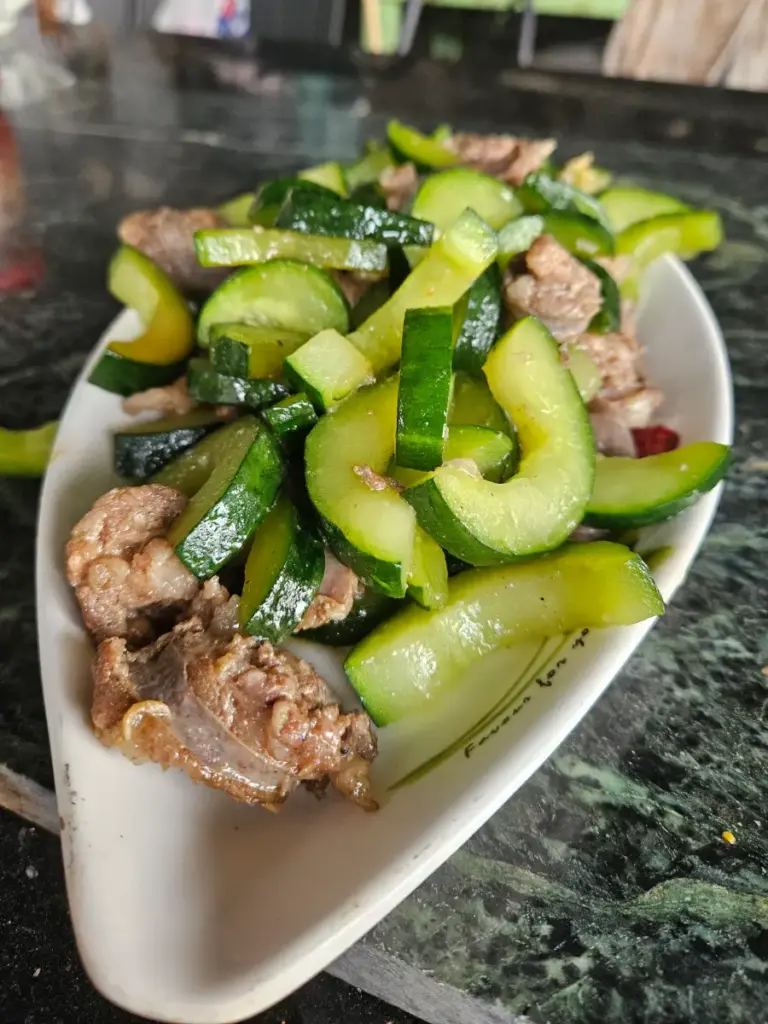 A plate of stir-fried cucumber and meat, part of the delicious local Taiwanese food we enjoyed every day.