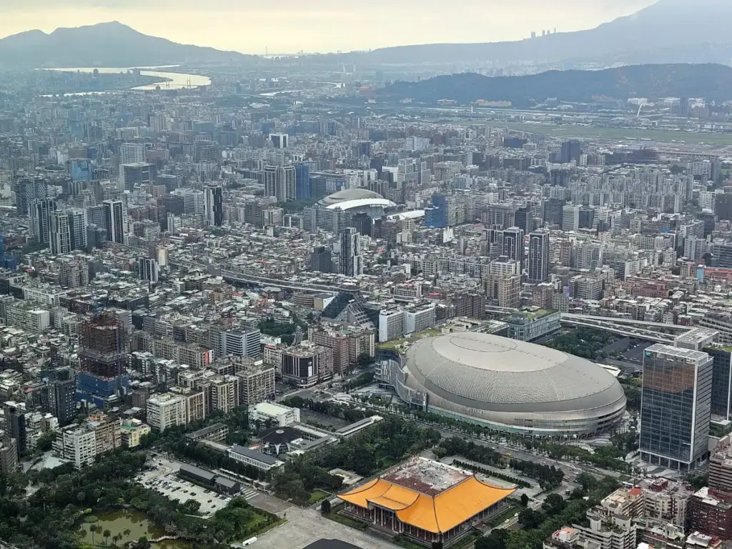 A daytime aerial view of Taipei from the Taipei 101 Observatory, overlooking the National Dr. Sun Yat-Sen Memorial Hall and Taipei Dome before the hike.